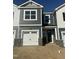 Charming townhome featuring a one-car garage, stylish gray siding, and a welcoming front entrance at 13 Silver Pne Dr, Angier, NC 27501