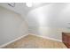 Attic area featuring wood look floors and natural lighting at 1301 Merrington Cir, Raleigh, NC 27615