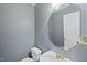 Powder room with a gray painted walls, mirror and a white pedestal sink at 1301 Merrington Cir, Raleigh, NC 27615
