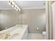 Bathroom featuring wallpaper, white tile floor and a double sink vanity at 1301 Merrington Cir, Raleigh, NC 27615