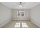 This is a bedroom featuring a ceiling fan and a window for natural lighting at 1301 Merrington Cir, Raleigh, NC 27615
