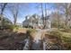Rear exterior featuring patio, sunroom addition and manicured lawn at 1301 Merrington Cir, Raleigh, NC 27615