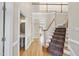 Inviting foyer features hardwood floors, an elegant staircase, and a view of the second-floor balcony at 1301 Merrington Cir, Raleigh, NC 27615