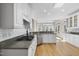 Spacious kitchen featuring white cabinets, granite countertops, stainless steel appliances, and hardwood floors at 1301 Merrington Cir, Raleigh, NC 27615