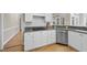 Bright kitchen featuring granite counters, white cabinets, stainless appliances, and hardwood flooring at 1301 Merrington Cir, Raleigh, NC 27615