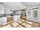 Bright, open kitchen with wood floors, white cabinetry, and eat-in island flows into a spacious living area at 1301 Merrington Cir, Raleigh, NC 27615