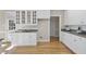 Open kitchen featuring granite countertops, white cabinetry, hardwood floors, and abundant natural light at 1301 Merrington Cir, Raleigh, NC 27615