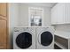 Laundry room featuring side-by-side washer and dryer and built-in cabinets and folding counter at 1301 Merrington Cir, Raleigh, NC 27615