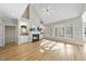 Bright living room with a fireplace, built-in shelving, large windows, and gleaming hardwood floors at 1301 Merrington Cir, Raleigh, NC 27615