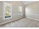 Neutral room with carpeted floors, chair railing, and two large windows offering lots of natural light at 1301 Merrington Cir, Raleigh, NC 27615