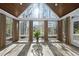 Bright sunroom with tiled floors, expansive windows, and wood ceilings at 1301 Merrington Cir, Raleigh, NC 27615