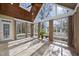 Vaulted sunroom with wood ceilings and many windows offering an abundance of natural light at 1301 Merrington Cir, Raleigh, NC 27615
