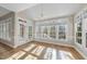 Light-filled sunroom with high ceilings, hardwood floors, and large windows at 1301 Merrington Cir, Raleigh, NC 27615