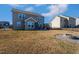 Large backyard with fire pit, patio, privacy screen, and views of the surrounding neighborhood at 140 Ashberry Ln, Franklinton, NC 27525