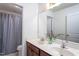 Bright bathroom featuring a double vanity, a large mirror, and a shower with a stylish striped curtain at 140 Ashberry Ln, Franklinton, NC 27525