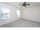 This bedroom has neutral walls, carpet, two windows with blinds, and a ceiling fan with lights at 140 Ashberry Ln, Franklinton, NC 27525