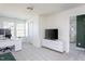 Bright bonus room features neutral walls, carpet, desk area, tv, and a doorway to another room at 140 Ashberry Ln, Franklinton, NC 27525