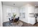 Bright breakfast nook featuring a pendant light, round table, and views through sunlit windows at 140 Ashberry Ln, Franklinton, NC 27525