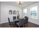 Modern dining room with a glass table, gray chairs, and decorative arched mirrors at 140 Ashberry Ln, Franklinton, NC 27525