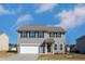 Charming two-story home with gray siding, black shutters, and a well-maintained front yard at 140 Ashberry Ln, Franklinton, NC 27525