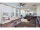 Bright living room with large windows, a comfortable leather sofa, and modern decor at 140 Ashberry Ln, Franklinton, NC 27525