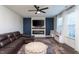 Cozy living room with a fireplace, plush leather sofa, and a ceiling fan at 140 Ashberry Ln, Franklinton, NC 27525