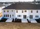 Aerial view of backyards with patios, lush landscaping, and newly constructed townhomes at 164 Kobus Ct, Garner, NC 27529