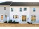 Exterior backyard view with sliding glass doors, landscaping, and neutral siding at 164 Kobus Ct, Garner, NC 27529