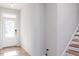 Bright foyer featuring a glass-paneled front door and wood-look flooring, leading to the staircase at 164 Kobus Ct, Garner, NC 27529