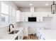 Kitchen featuring an undermount sink, modern fixtures, white countertops and backsplash at 164 Kobus Ct, Garner, NC 27529