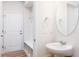 Stylish powder room featuring a pedestal sink, round mirror, and well-placed lighting fixtures and storage space at 164 Kobus Ct, Garner, NC 27529