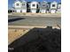 New townhomes along a street, showcasing consistent architectural styles and community development under a sunny sky at 17 Silver Pne Dr, Angier, NC 27501