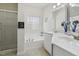 Bright bathroom featuring double sinks, tub, tiled floor and a glass enclosed shower at 1709 Heisser Ln, Fuquay Varina, NC 27526
