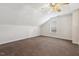 Spacious bedroom with unique ceiling design, dormer window, and neutral carpet at 1709 Heisser Ln, Fuquay Varina, NC 27526