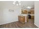 Open concept dining area adjacent to kitchen featuring hardwood floors and modern lighting at 1709 Heisser Ln, Fuquay Varina, NC 27526
