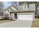 Charming single-Gathering home featuring neutral siding, attached two-car garage, and manicured landscaping at 1709 Heisser Ln, Fuquay Varina, NC 27526