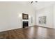 Bright living room with vaulted ceiling, wood flooring, fireplace, and natural light from large windows at 1709 Heisser Ln, Fuquay Varina, NC 27526