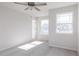 Bright bedroom featuring a ceiling fan, carpeted floor, and two windows letting in natural light at 172 Kobus Ct, Garner, NC 27529