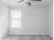 A cozy bedroom with plush carpeting, a ceiling fan, and a bright window offering natural light at 172 Kobus Ct, Garner, NC 27529