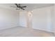 Spacious bedroom featuring neutral carpet, ceiling fan, and view to an ensuite bathroom at 172 Kobus Ct, Garner, NC 27529