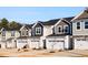 View of home exteriors with garages, various colors of siding, and front yards at 172 Kobus Ct, Garner, NC 27529