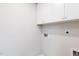 Laundry room features white cabinets, utility connections, and access for laundry needs at 172 Kobus Ct, Garner, NC 27529
