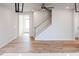 Spacious living room featuring wood floors, stairs, and a view to the front door at 172 Kobus Ct, Garner, NC 27529
