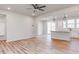 Bright open-concept living room with hardwood floors, kitchen, and backyard access at 172 Kobus Ct, Garner, NC 27529
