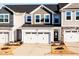Charming townhome featuring a two-car garage, modern architecture, and well-manicured landscaping at 172 Kobus Ct, Garner, NC 27529