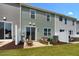 Townhome backyard with patio area for outdoor seating and entertaining, plus lush green lawn at 176 Kobus Ct, Garner, NC 27529