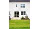 Home exterior displaying a well-maintained backyard, patio, sliding glass door and lawn at 18 Twin Birch Dr, Angier, NC 27501