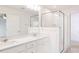 Modern bathroom featuring a double sink vanity, a glass-enclosed shower, and tiled floors at 18 Twin Birch Dr, Angier, NC 27501