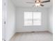 Cozy bedroom featuring a ceiling fan, carpet floors, and large window with blinds at 18 Twin Birch Dr, Angier, NC 27501