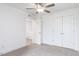 Well-lit bedroom with a ceiling fan, carpet floors, and closet with paneled doors at 18 Twin Birch Dr, Angier, NC 27501